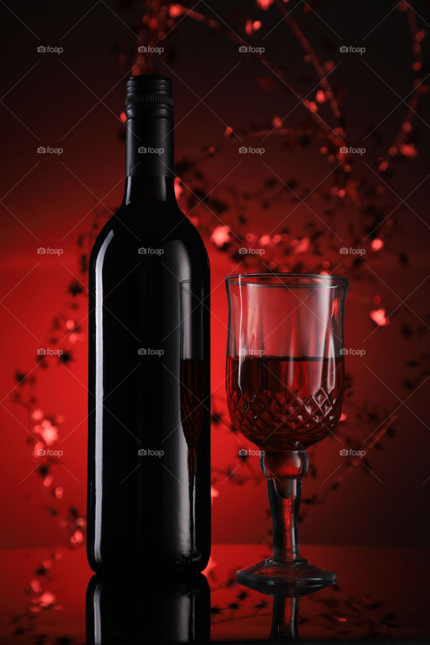 Wine bottle and glass with festive holiday feel