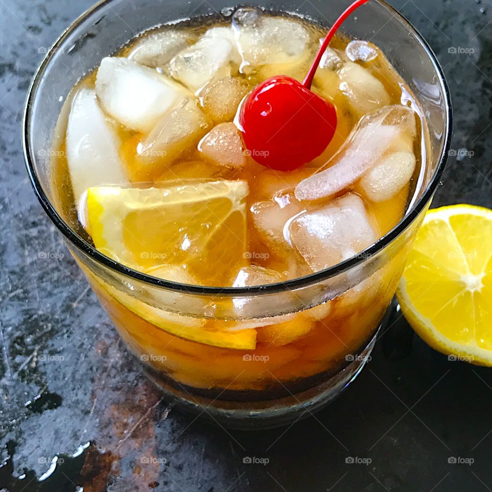 Whiskey sour with lemon and cherry 