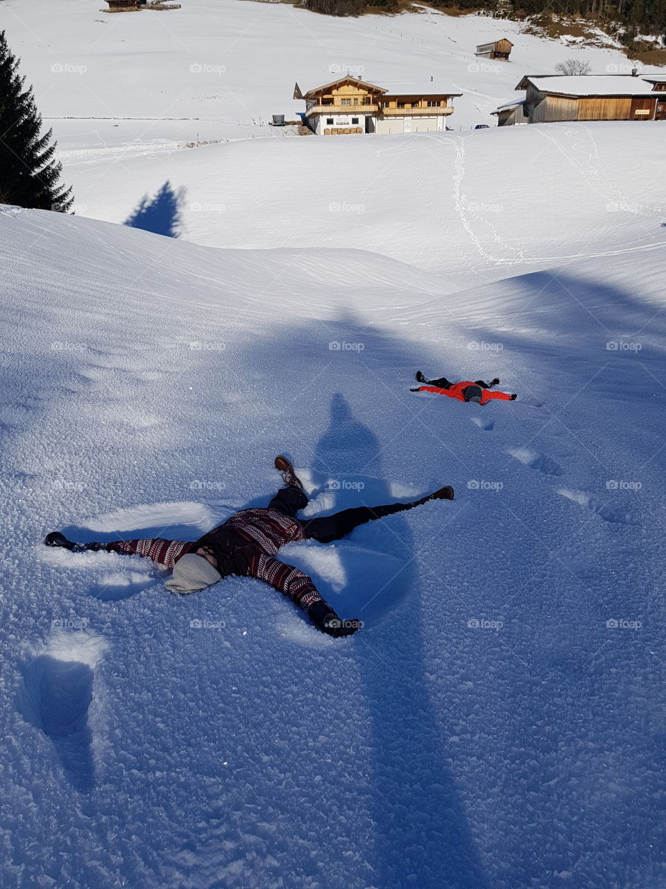 making a snow angel in the deep snow