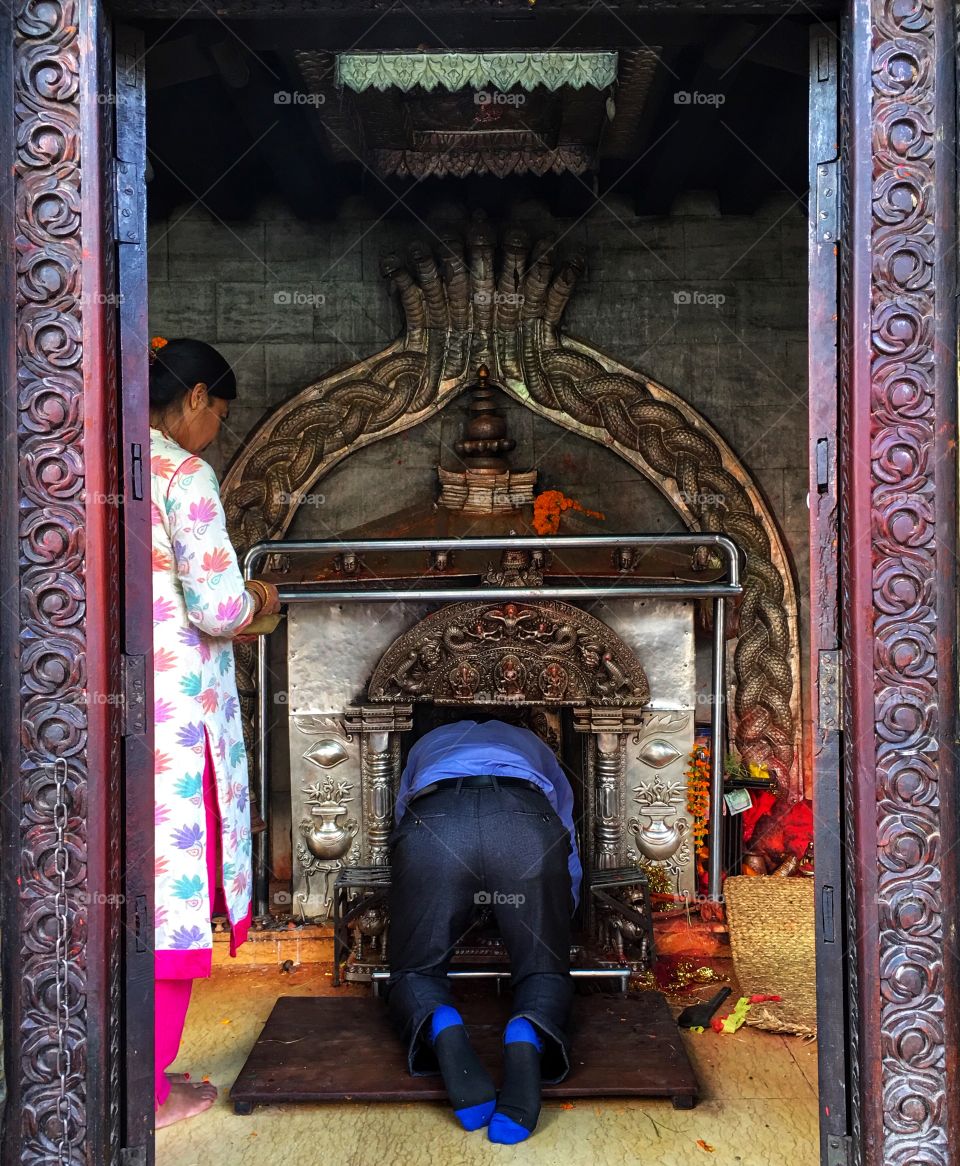 Devotee of God praying/bowing  inside temple 