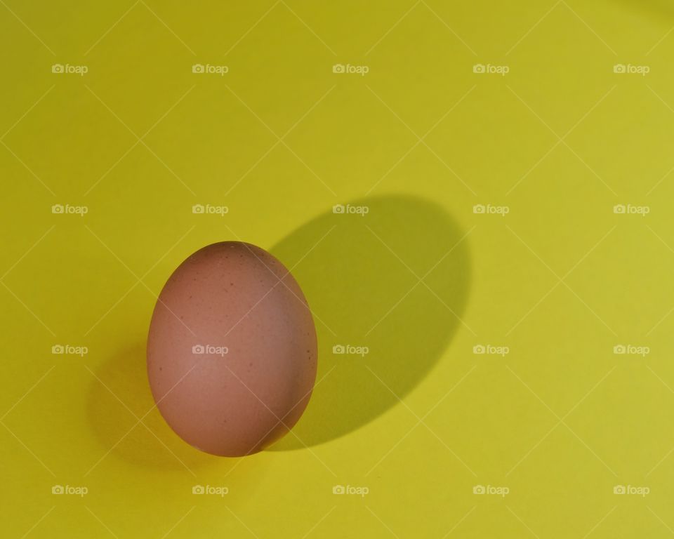 Egg on yellow background