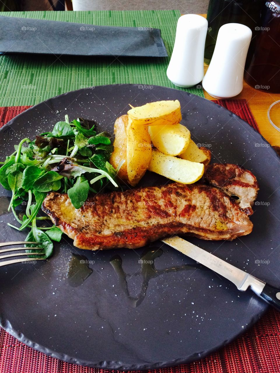 Grilled beef, baked potatoes. Grilled beef, baked potatoes and green salad 