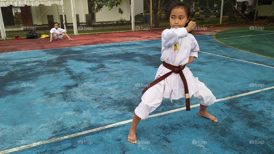 a kid training karate outdoor