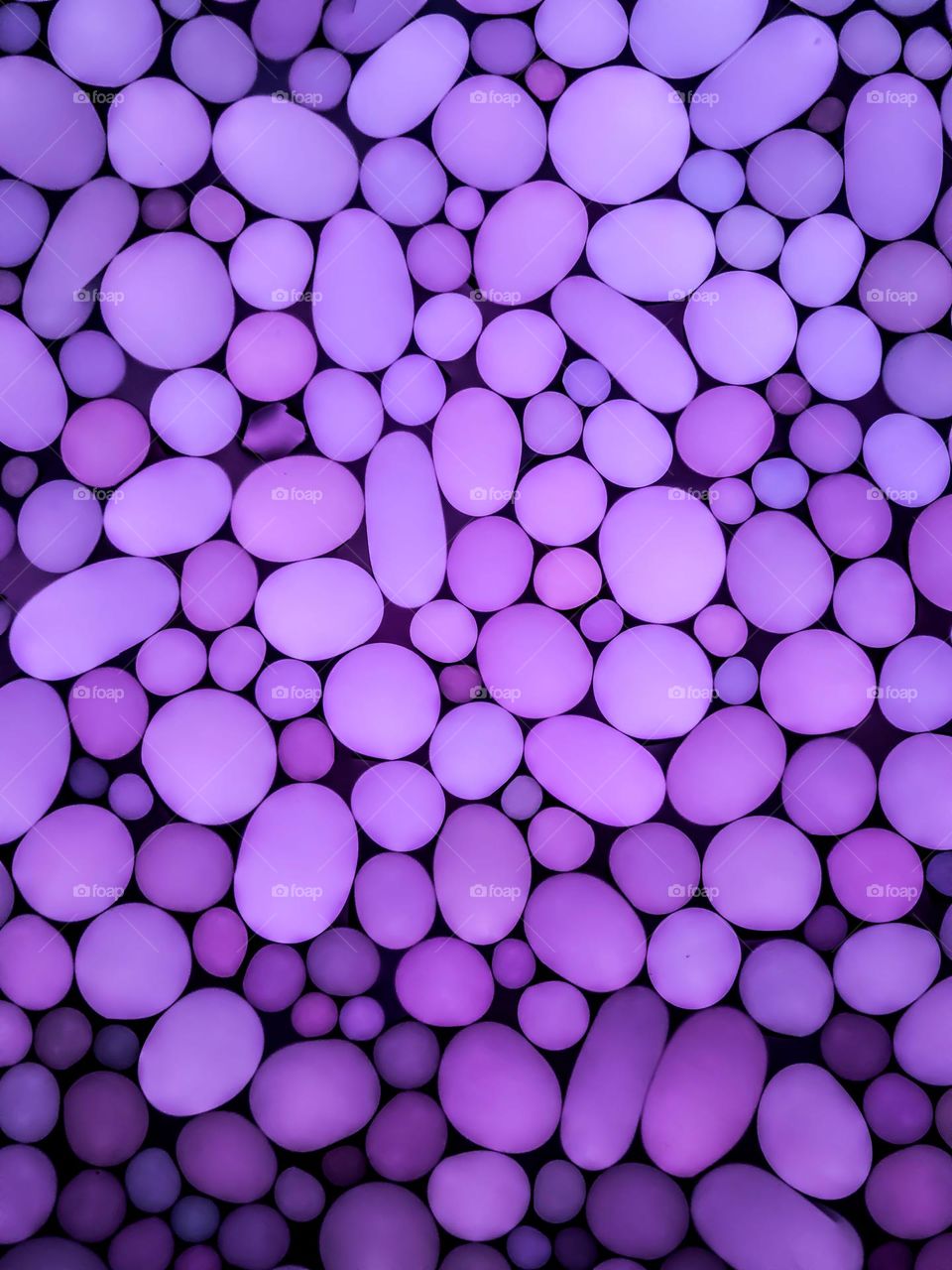 Multiple stone like egg shaped spheres, in a purple ombré tone, abstract calming and soothing 