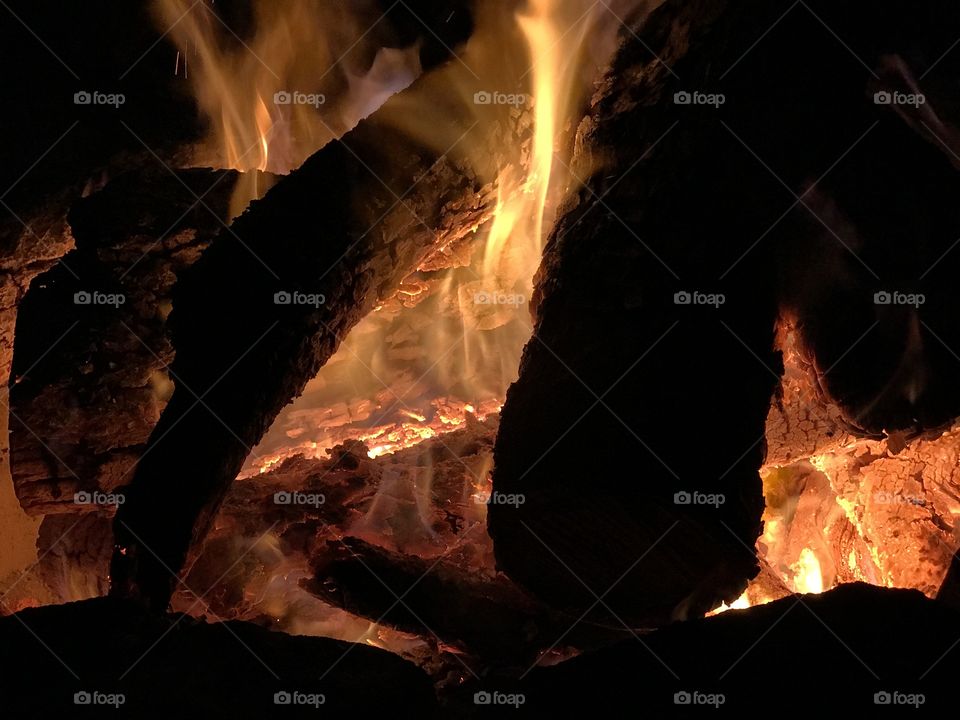 Burning logs in campfire.