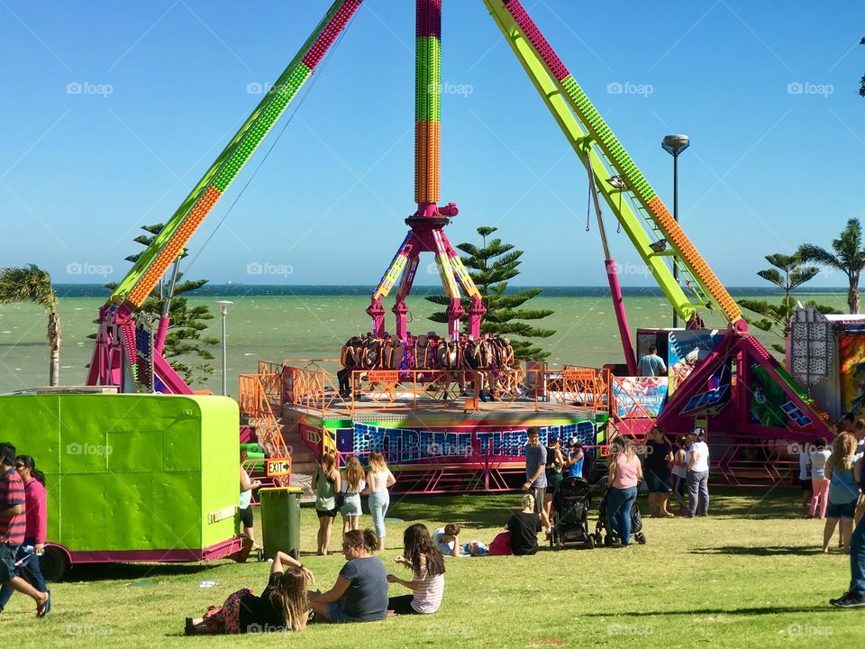 Fluorescent greens at Outdoor amusement ride by ocean