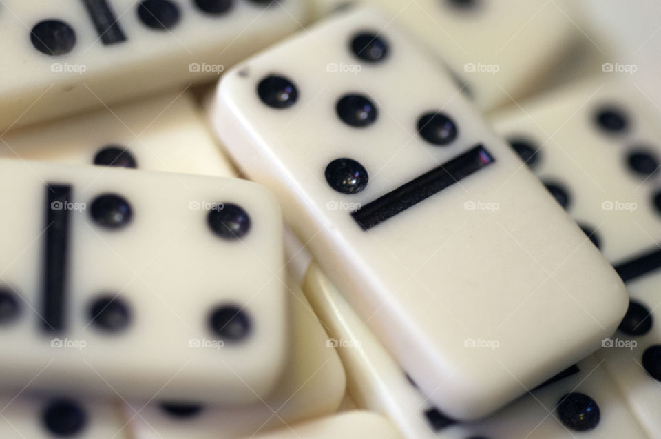 Close-Up of White Domino with Black Spots