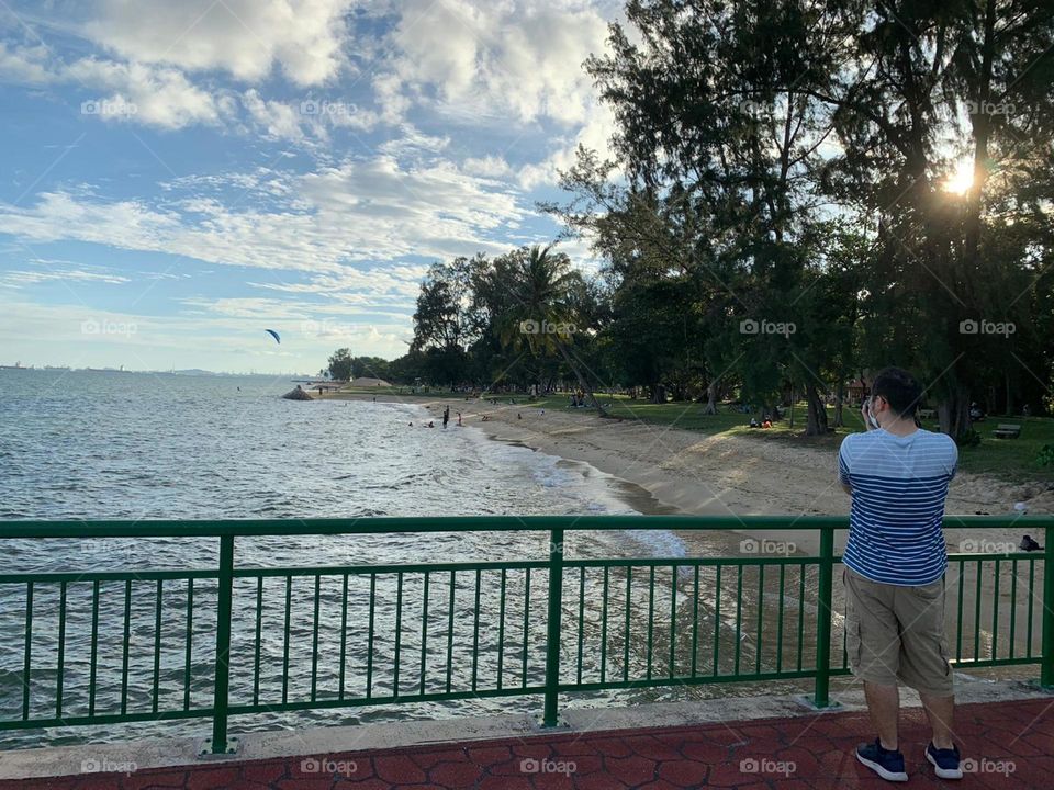 Beautiful scenery by the beach with blue cloudy sky