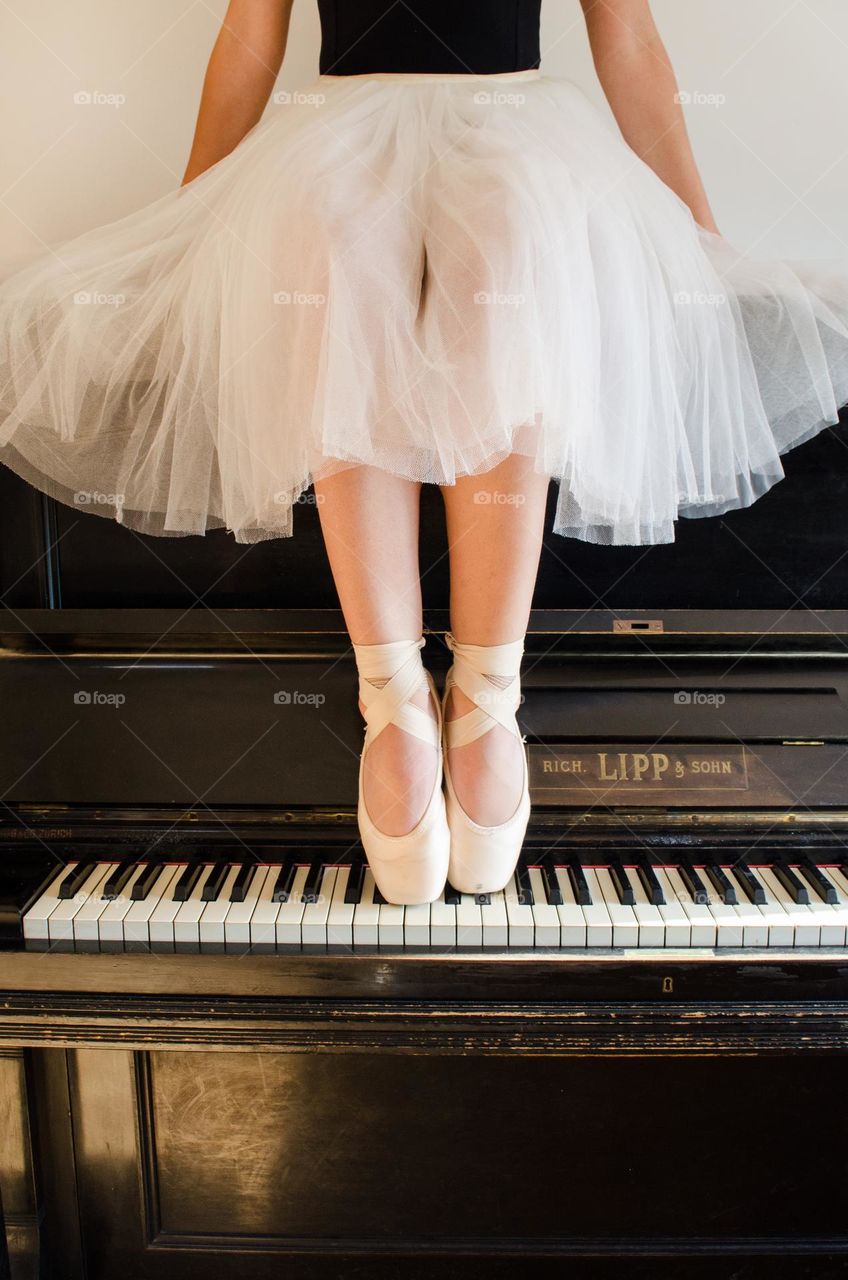 Ballerina Standing on A Piano