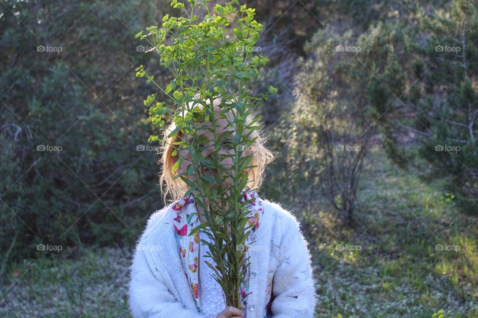 Girl hiding behind grass