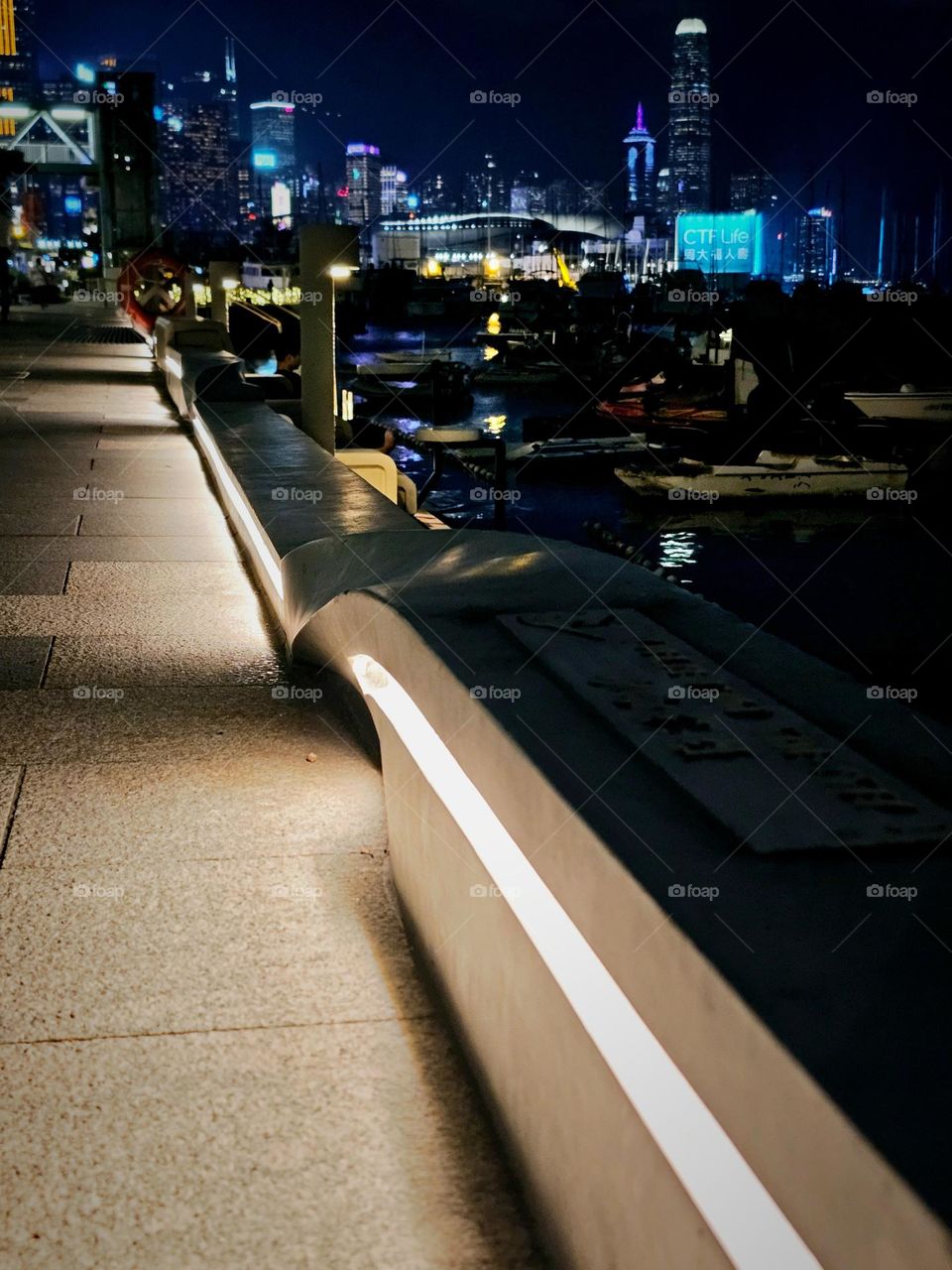 Night walk along the pier with nightview of the cityscape