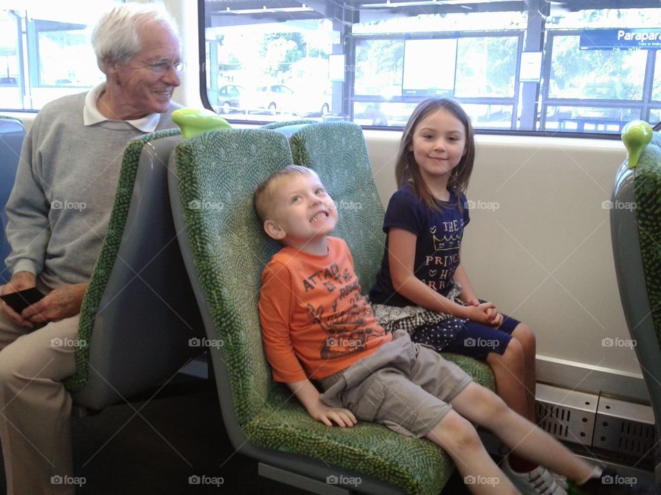 Grandfather and siblings in bus