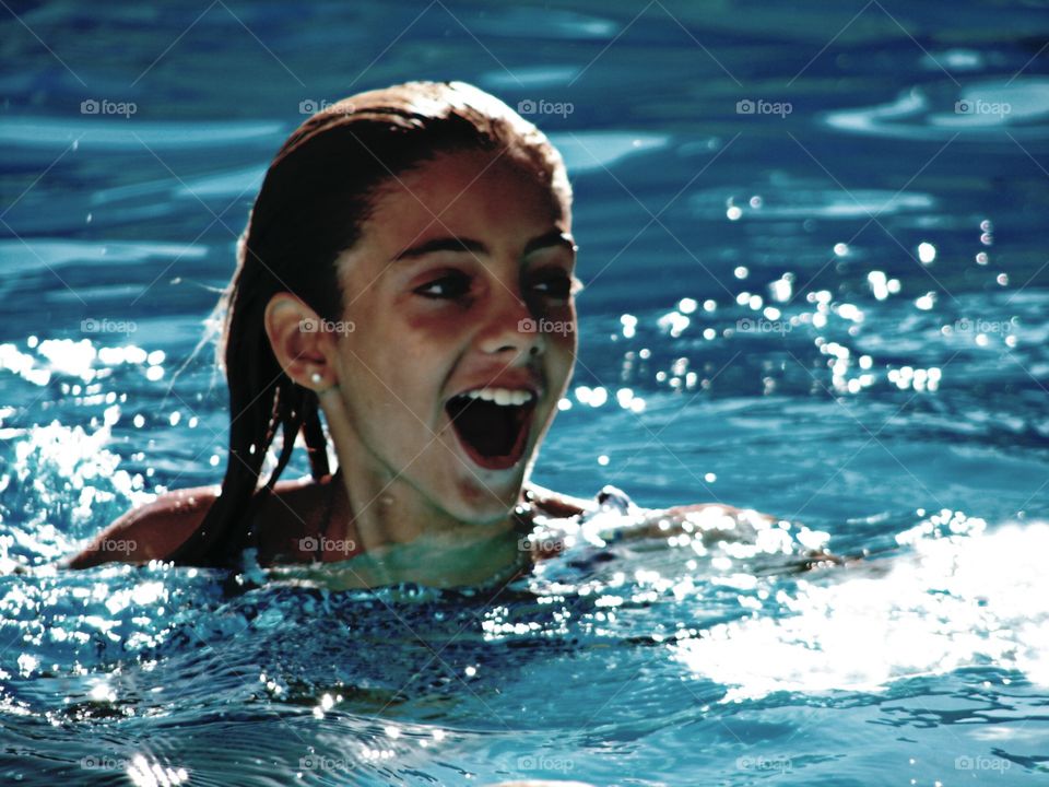 Young woman enjoying in swimming pool