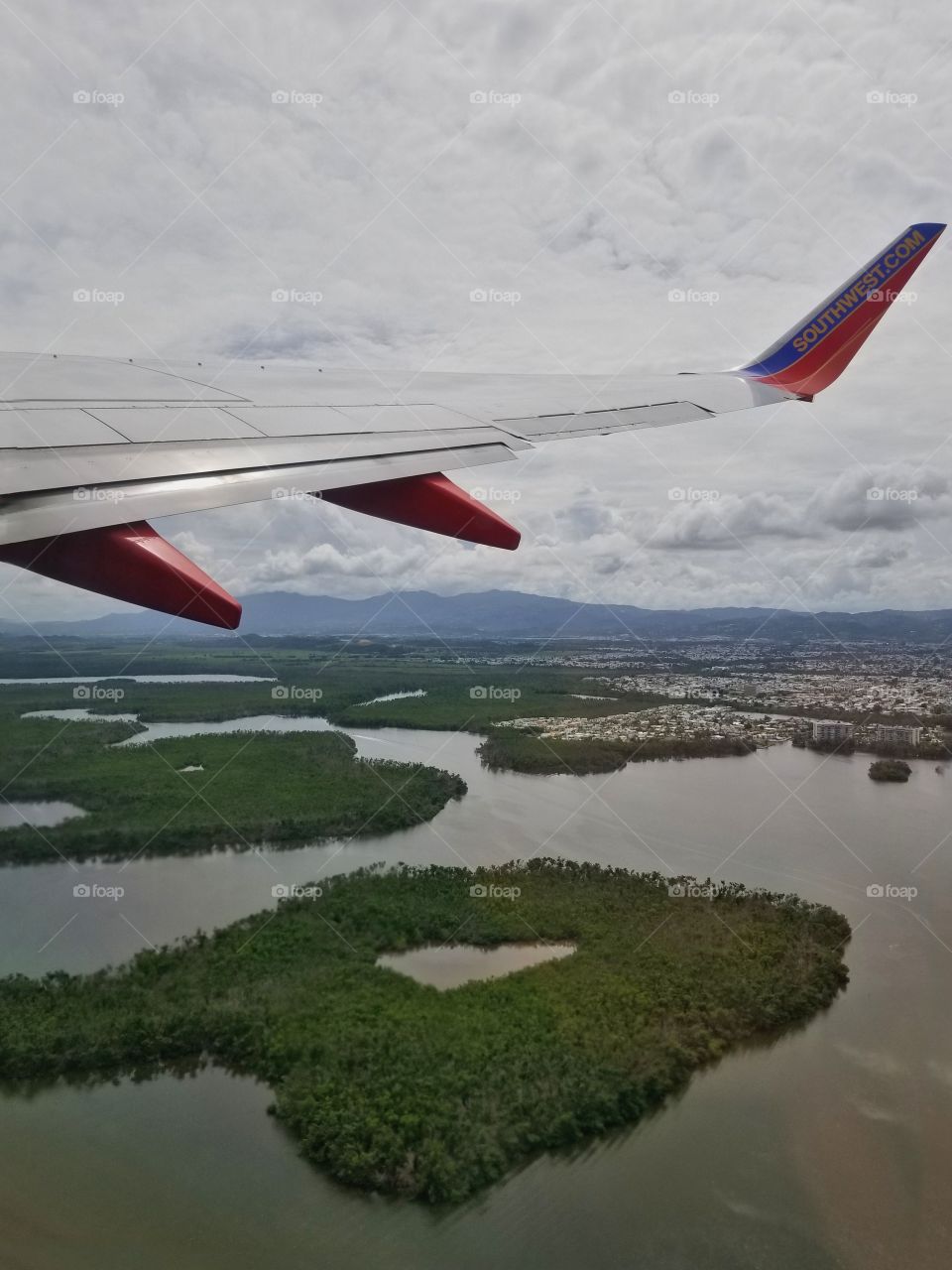 Flight home.. From San Juan Puerto Rico.. Looking down that little island looks like a heart in the middle💚