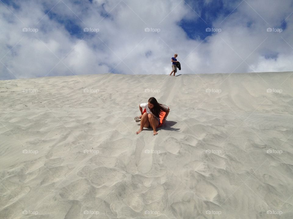 Sledding down a sand dune!