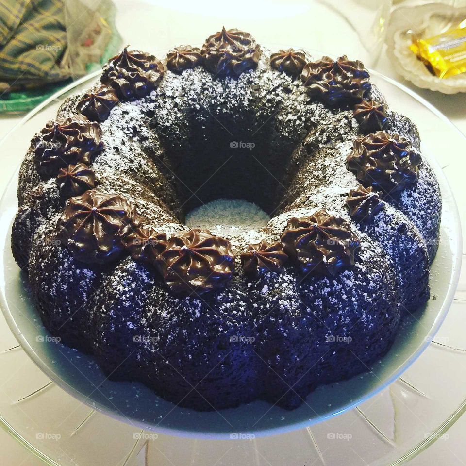 a delicious kahlua cake topped with chocolate ganache and a light dusting of powdered sugar.