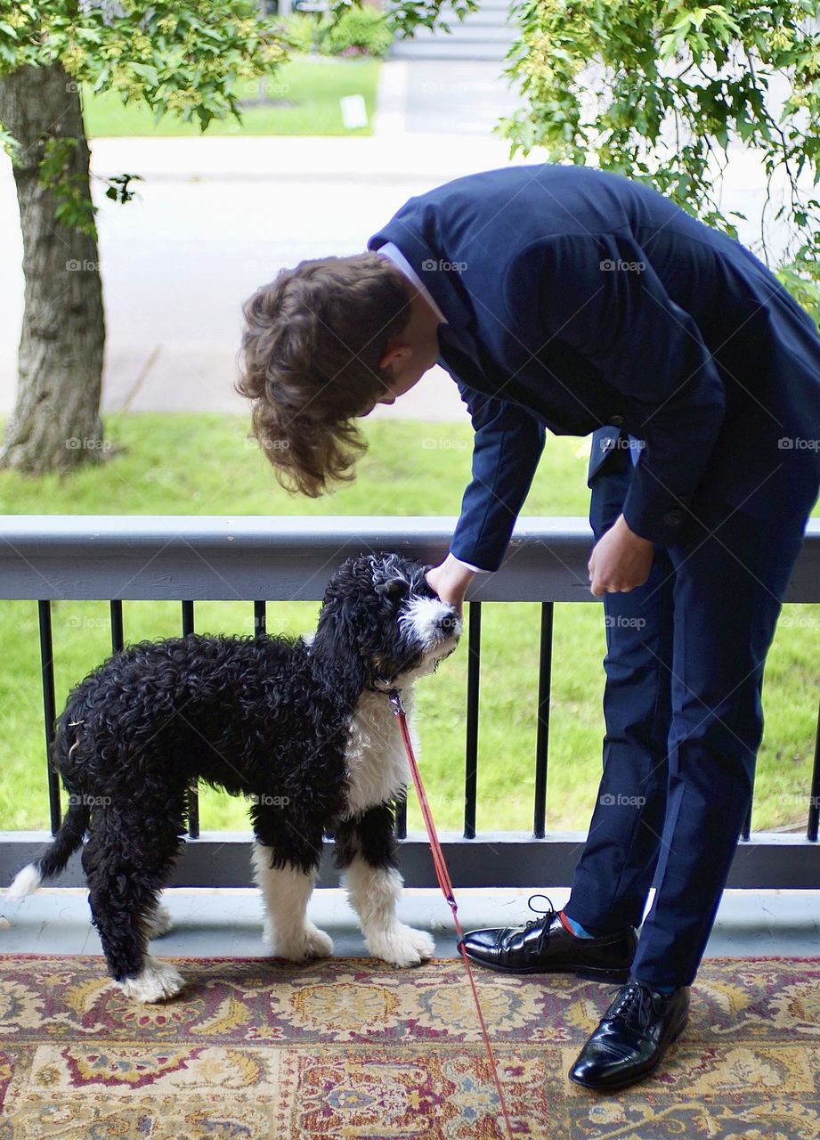 A boy and his dog share a moment.