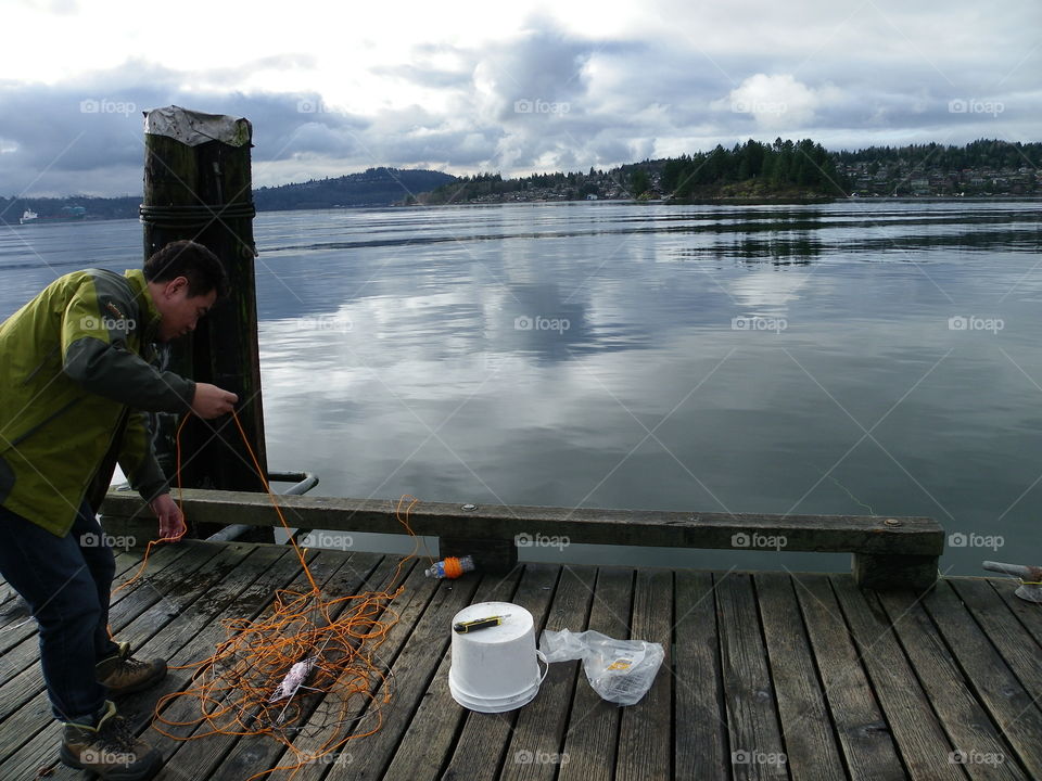 Setting the crab trap. Setting the crab trap from dock