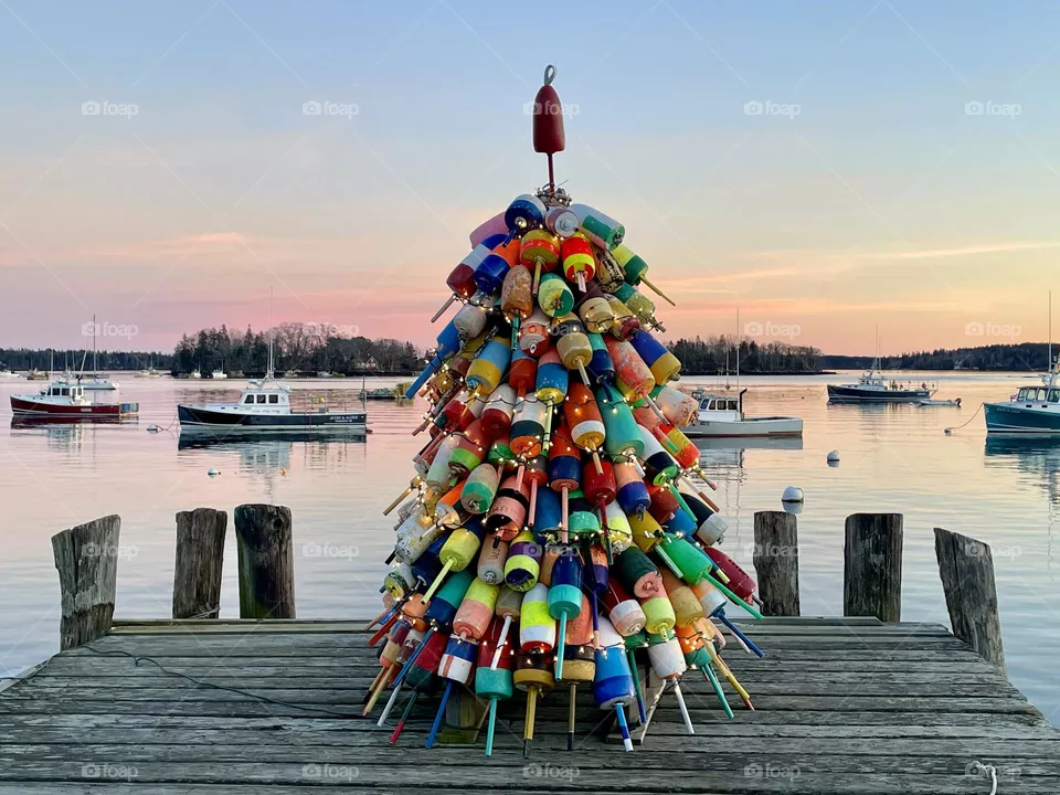 A Christmas tree made of pot buoys sits at the end of a wharf in Friendship Harbor, Maine.