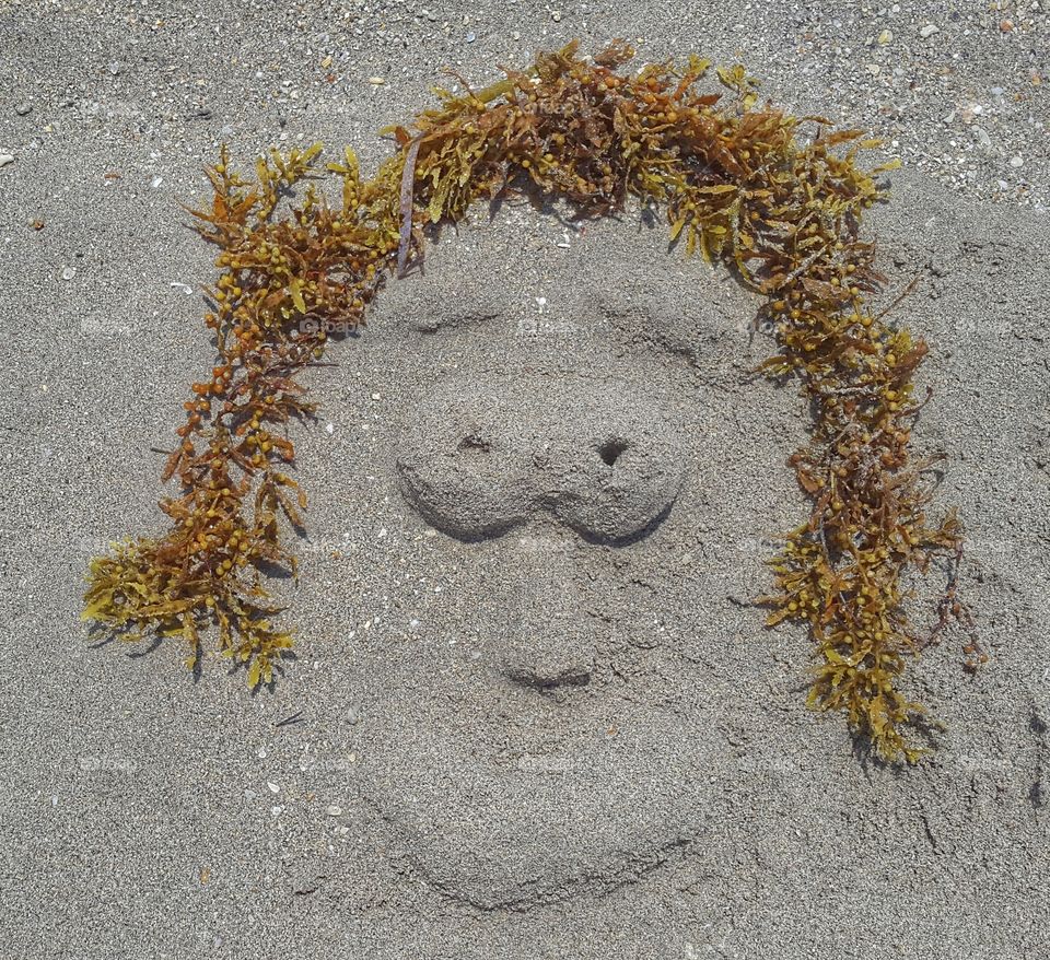 face in the sand