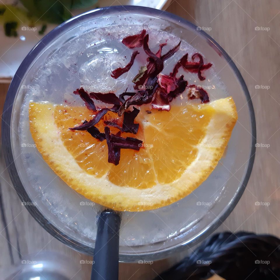 lemonade with slice of orange and flowers of lavender mixed with ice