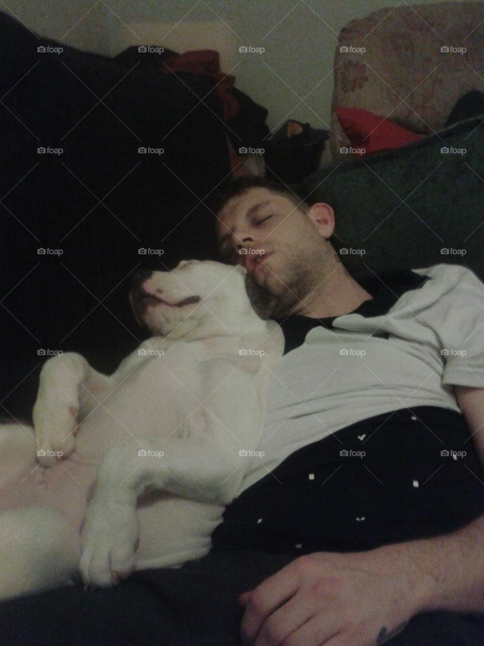 Man and dog sleeping together. Cuteness is not the word.