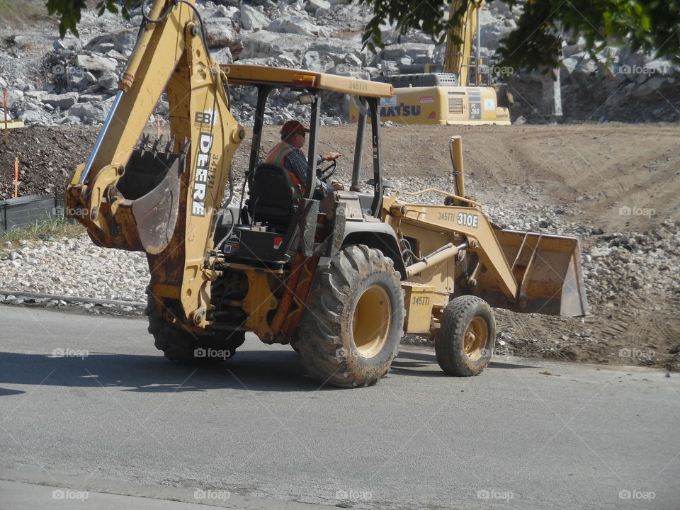backhoe. This is a picture of a backhoe working on a construction 👷 site that I saw on my way to the Gulf of Mexico. 👣 🚶 🏃 🔥