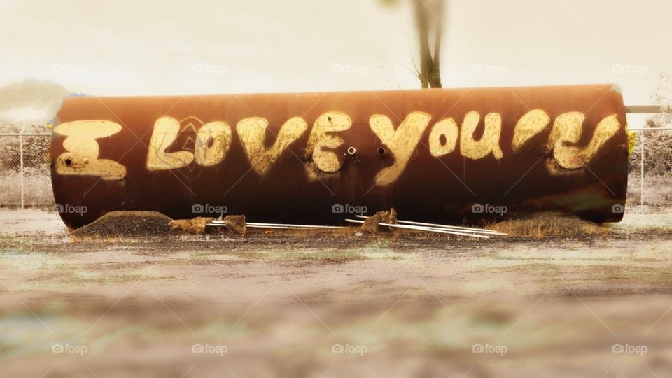 I love you graffiti on rusty pipe