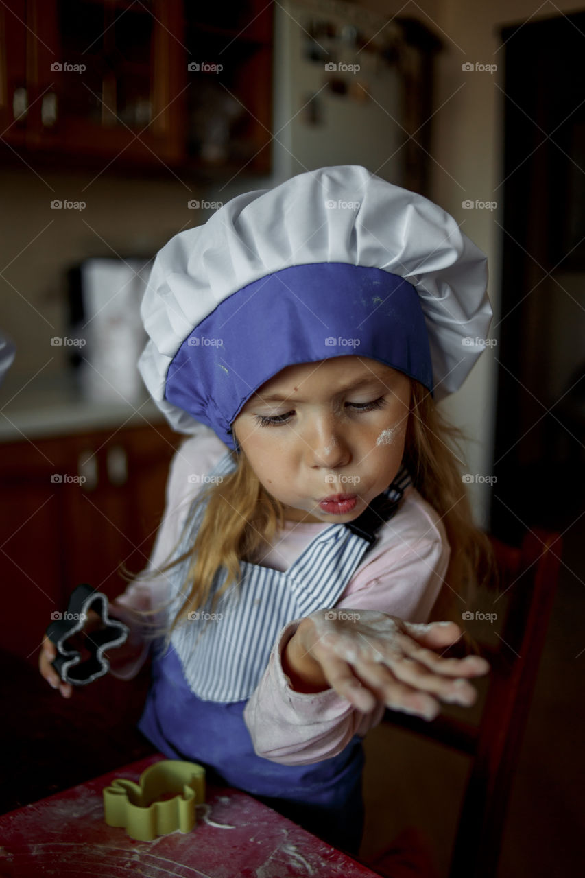 Little sisters cooking the biscuits 