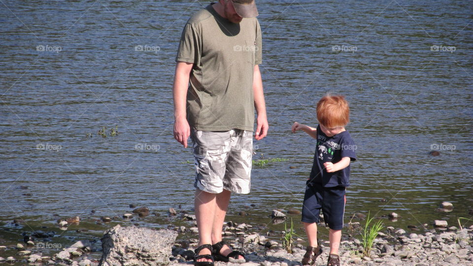 child and adult on beach