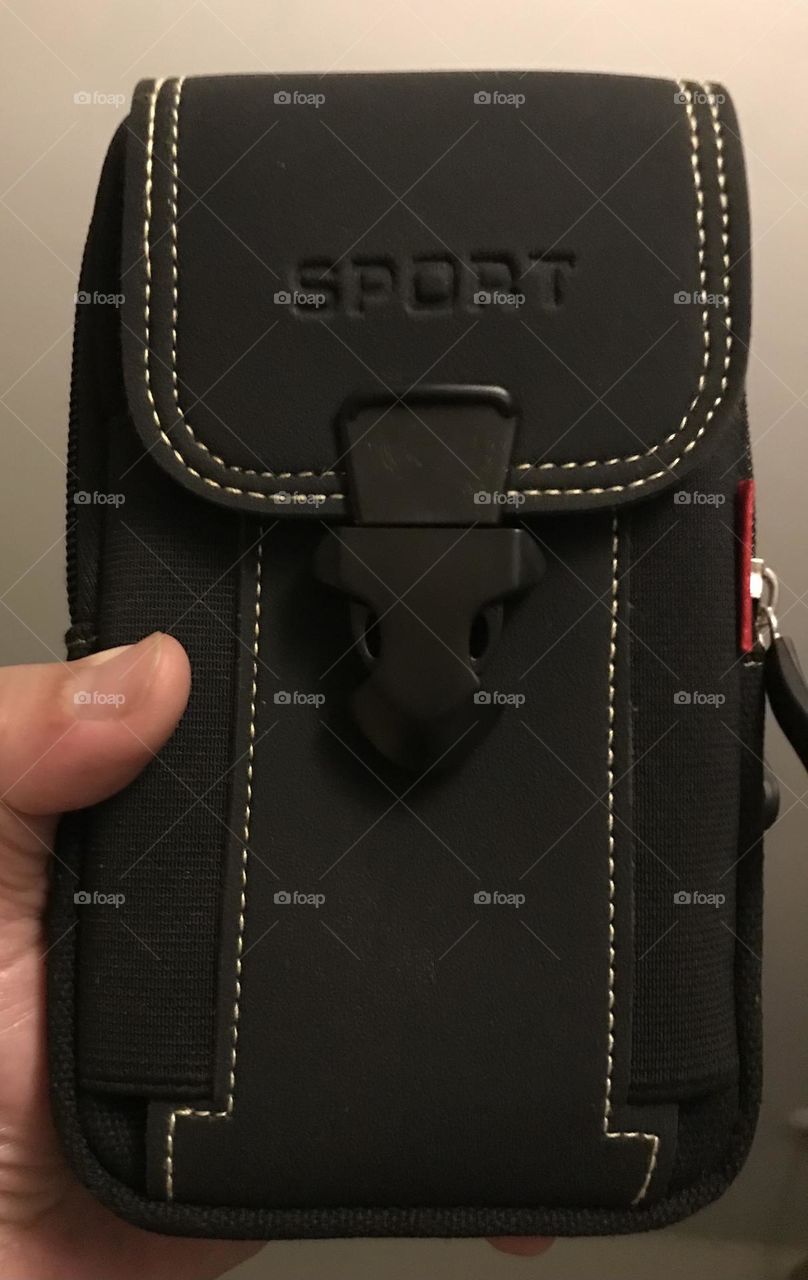 A purposeful iPhone pouch wearable on a waist belt.