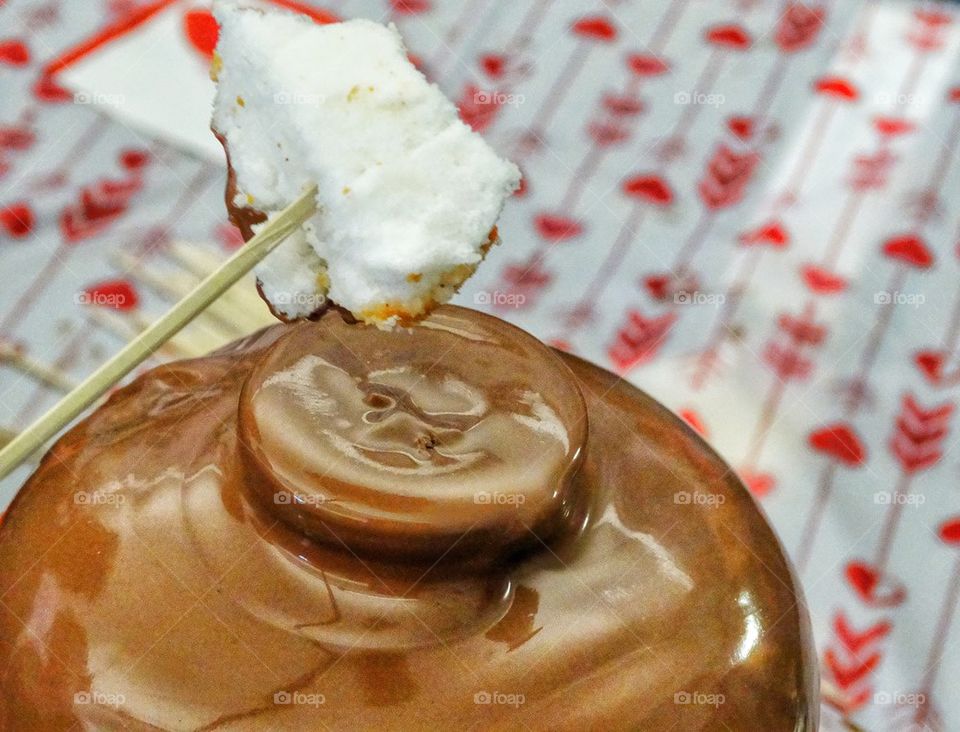 Dipping Cake In Chocolate Fondue. Angel Food Cake Dipped In Melted Chocolate
