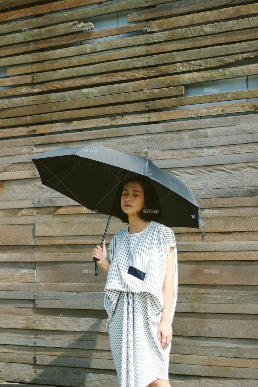 beautiful woman carrying an umbrella