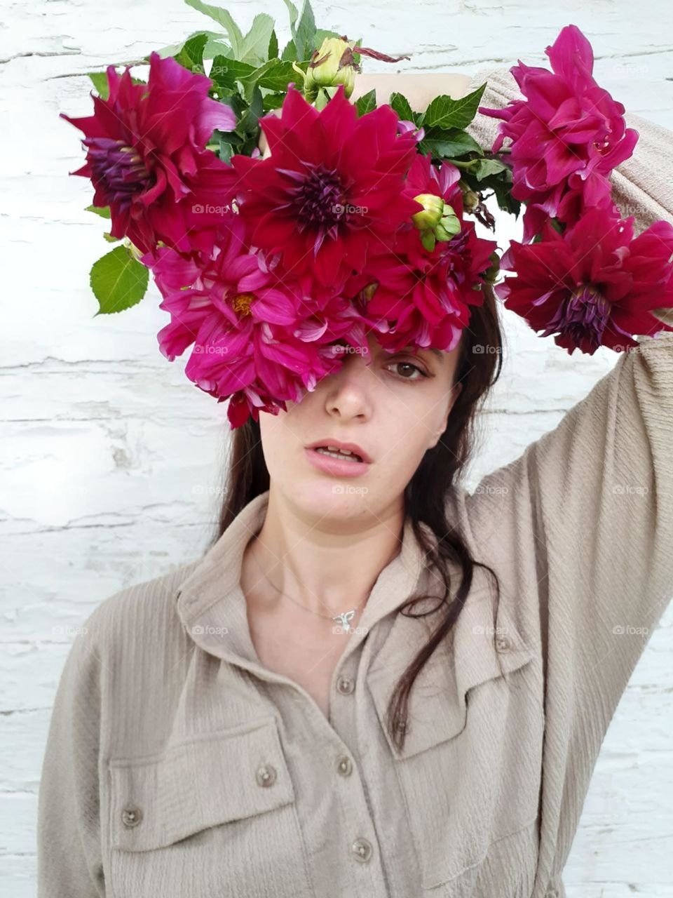 female original portrait with red flowers grown in a home flowerbed