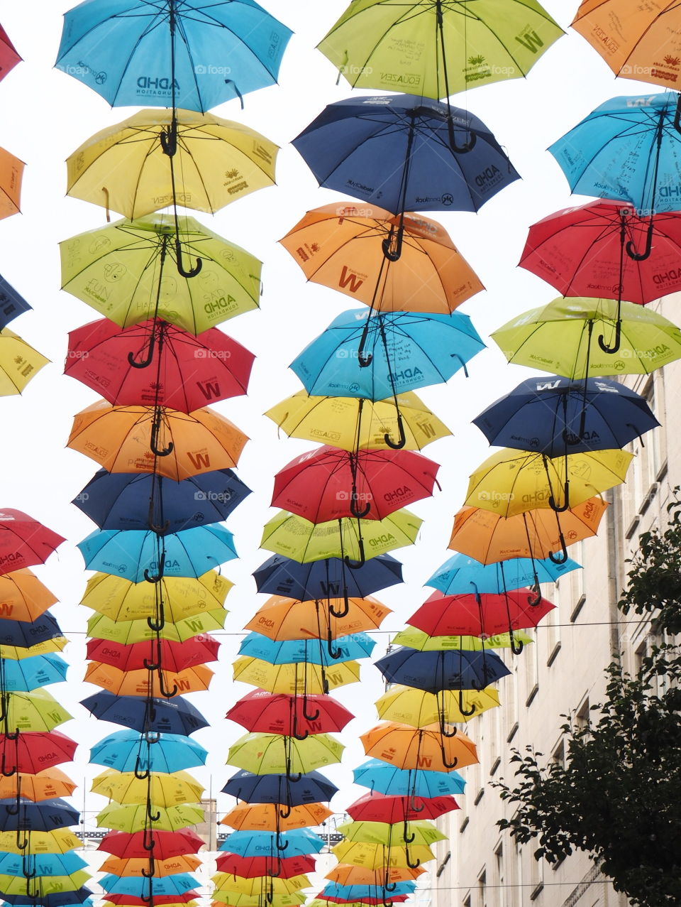 Colorful, bright umbrellas hanging in the streets of Liverpool, England on a sunny and bright autumn day.