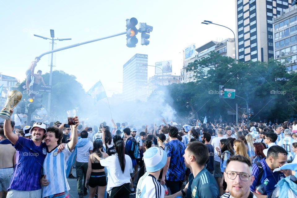 Buenos-Aires - 18.12.2022: Football fans of national team of Argentina in t-shirts on national team celebrating victory on the streets