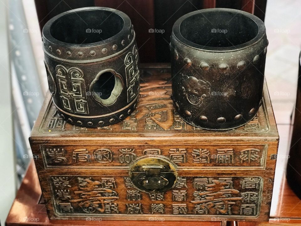 Chinese ancient wooden storage box with Chinese beautiful architecture and letters on the box and some Diya holders 