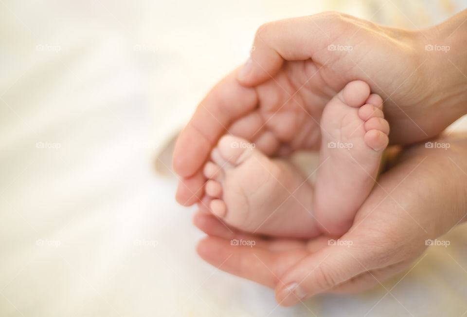A hand holding cute baby foot