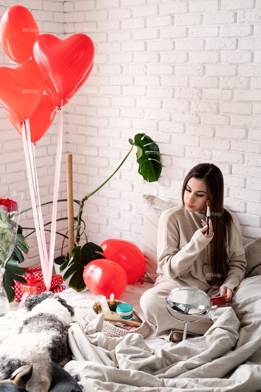 woman using cosmetics at home