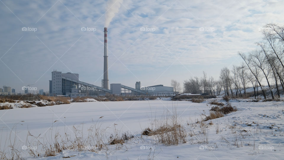 the factory near the lake in winter