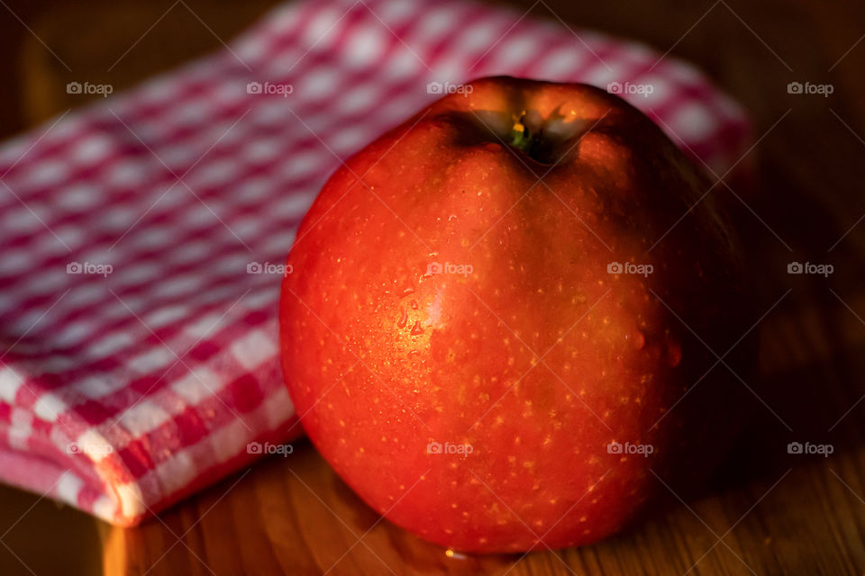 Red apple illuminated with sunrises