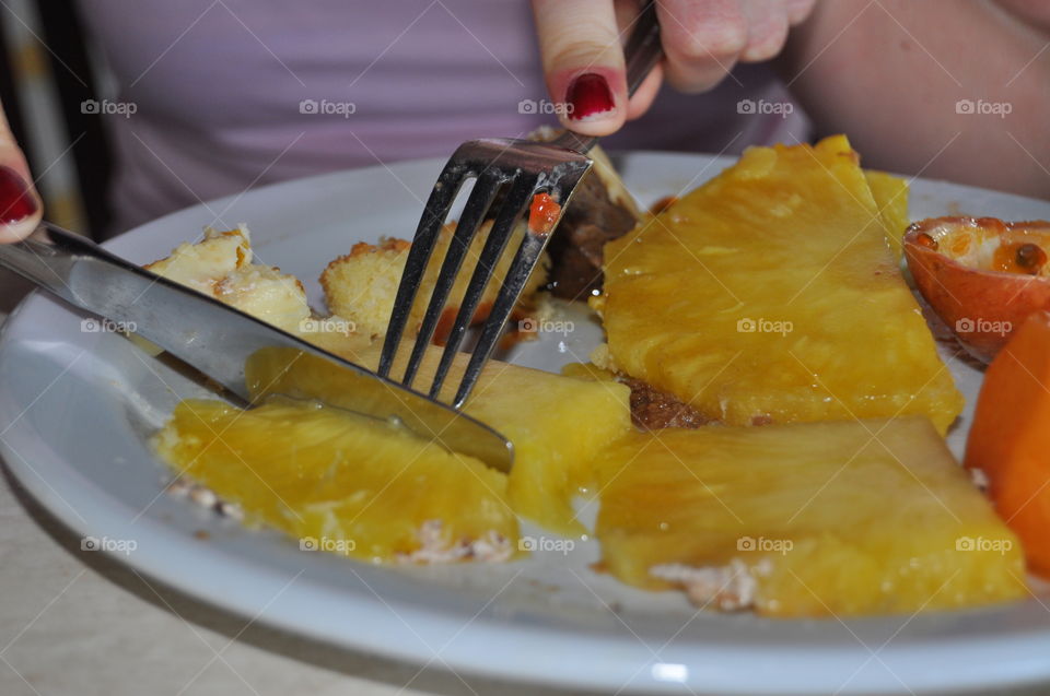 eating pineapple