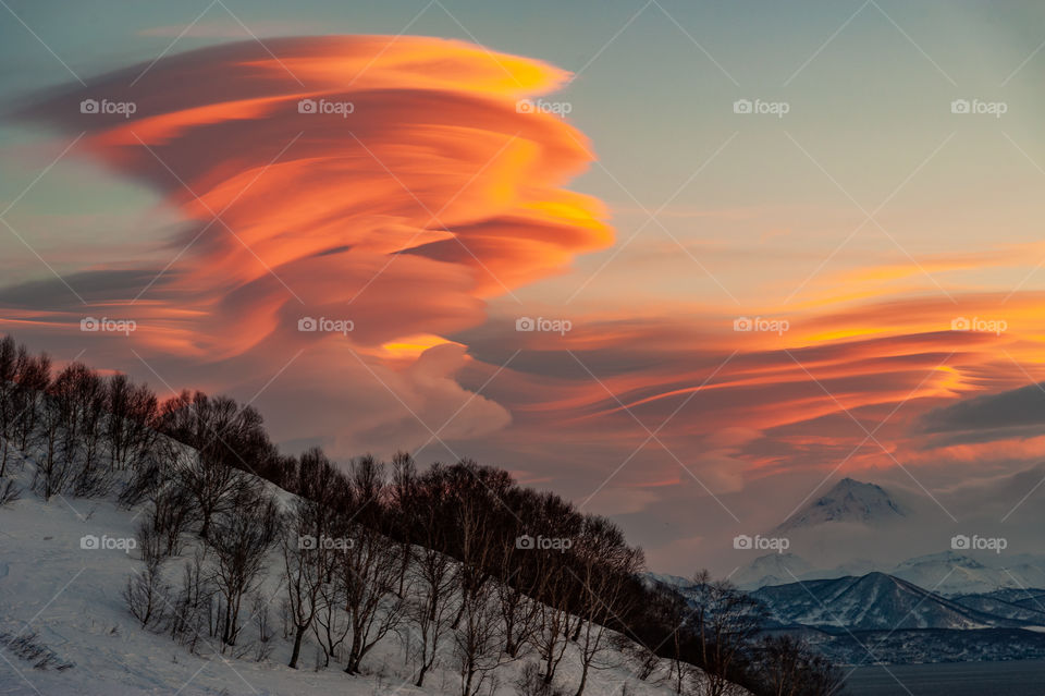 Kamchatka volcanic sunset with lenticular clouds