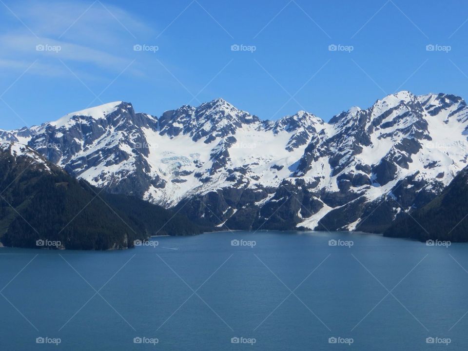 Snowy mountains and idyllic lake