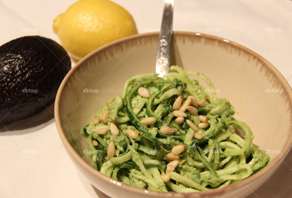 Green pasta on bowl