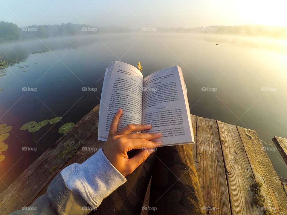 Reading a book on the river.