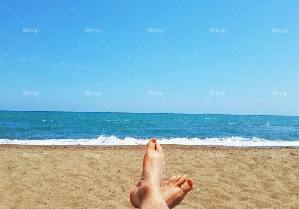 My feet on vacation. I am taking my vacation in Antalya, Turkey. It is a great sunny day, perfect beach and warm sea.