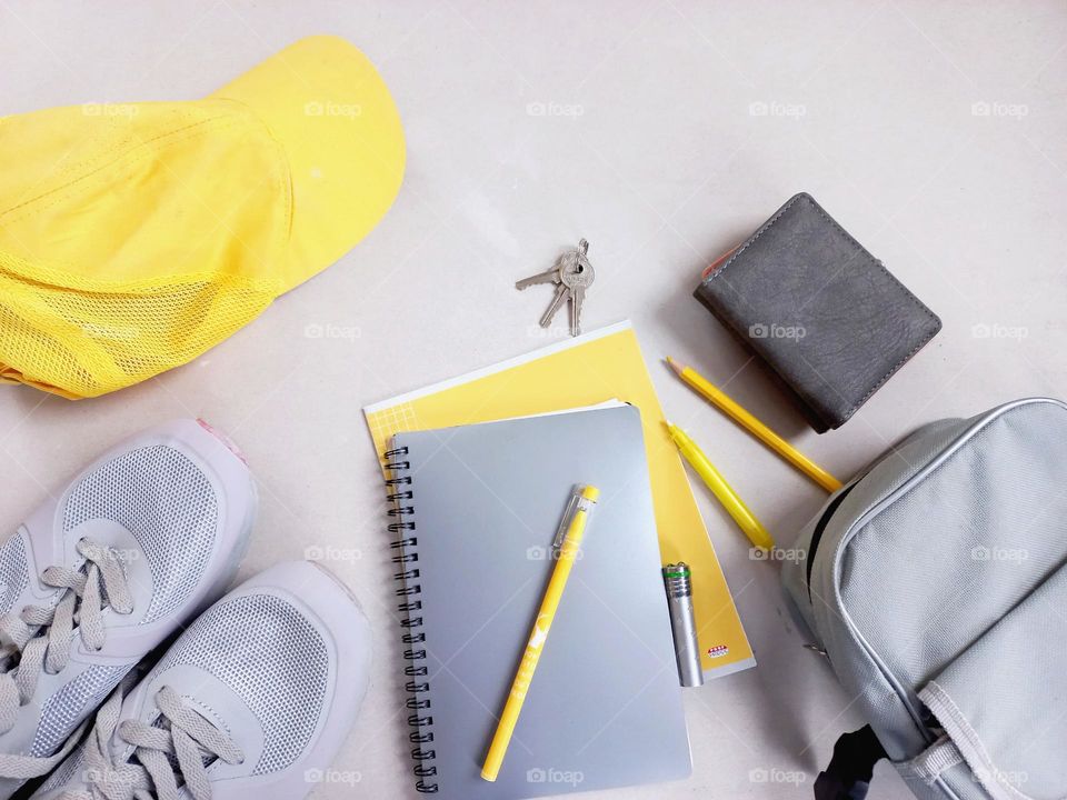 yellow cap and notebook, yellow marker аnd pen.