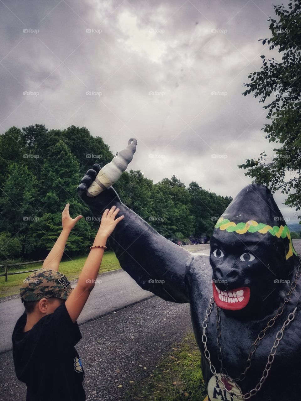 Kid Posing With Gorilla Statue