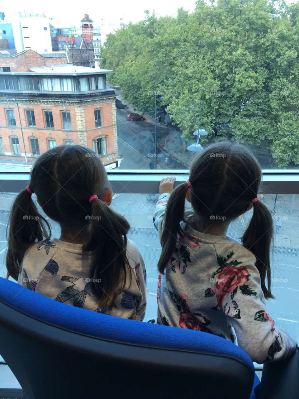 Twin girls looking out onto the giants visiting Liverpool